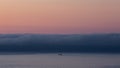 Fishing boat heading out at sunset Royalty Free Stock Photo