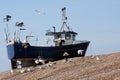 Fishing boat high up shingle bank Royalty Free Stock Photo