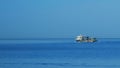 Fishing Boat On The Horizon At Sea. Abstract Small Waves On Calm Water Surface In Motion. Still. Royalty Free Stock Photo