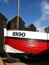 Fishing Boat and huts on the beach at Hastings East Sussex, England.