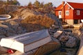 Fishing boat inverted upside down on the rocks