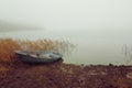 Fishing boat on the lake in the fog Royalty Free Stock Photo