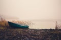 Fishing boat on the lake in the fog Royalty Free Stock Photo