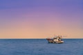 Fishing boat in late sunset Royalty Free Stock Photo