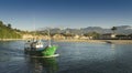 Fishing boat leaving the bay in the port of the town of Ribadesella in Asturias.