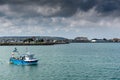 Fishing boat leaving the harbor of Barfleur, Royalty Free Stock Photo