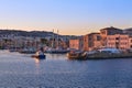 Fishing boat leaving Old Venetian port of Chania, Crete, Greece at sunrise. Sailboats, yachts, Grand Arsenal, Old