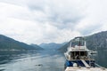 Fishing Boat in the little Harbor of Kotor. Lake with small yachts and coast towns and mountains in the background. Pier with Royalty Free Stock Photo