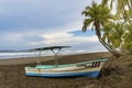 Fishing boat on a lonely beach in Costa Rica. Royalty Free Stock Photo