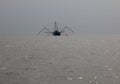 Fishing boat in misty weather. Hong Kong. Royalty Free Stock Photo