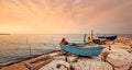 Fishing boat moored on cliff at sunset. Royalty Free Stock Photo