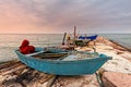 Fishing boat moored on cliff at sunset. Royalty Free Stock Photo