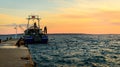 Fishing boat moored or docked at pier in sunset Royalty Free Stock Photo