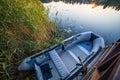 Fishing boat moored nearby the pier on calm water lake Royalty Free Stock Photo