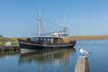 Fishing boat moored in port is reflected in the water Royalty Free Stock Photo