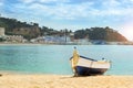 Fishing boat moored on sandy beach. Blanes, Spain Royalty Free Stock Photo