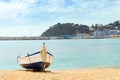 Fishing boat moored on sandy beach. Blanes, Spain Royalty Free Stock Photo