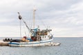 Fishing boat mooring at the pier in mediterranean sea. Royalty Free Stock Photo