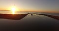 A fishing boat moving slowly during sunrise