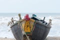 A fishing boat nautical vessel used in fishing industry spotted in a tropical sea beach. Vertical horizon. Mode of water