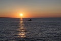 Fishing boat passing in sunset Royalty Free Stock Photo