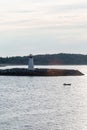 Fishing Boat Past Lighthouse in Dawn Light Royalty Free Stock Photo