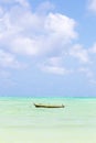 Fishing boat on picture perfect white sandy beach with turquoise blue sea, Paje, Zanzibar, Tanzania.