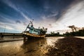 Fishing boat ran aground on the mud beach Royalty Free Stock Photo