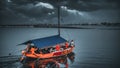 Fishing boat reflected on a tranquil sea under a cloudy evening sky Royalty Free Stock Photo