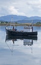 Fishing boat reflected in the water Royalty Free Stock Photo