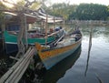 The fishing boat rests next to the riverside house in the evening. Tangerang Indonesia, July 14 2023.