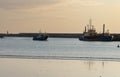 Fishing boat returning to port at dusk in Povoa de Varzim, Portugal. Royalty Free Stock Photo