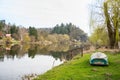 A fishing boat on the river shore surrounded by trees whiteout leaves spring day Royalty Free Stock Photo