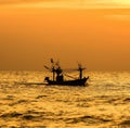 Fishing boat sailing on the sea at sunset Royalty Free Stock Photo