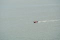 Fishing boat sailing on sea surface. Aerial Shot Over Speed Boat with small waves in Ocean. Fast speed boat moving on the water Royalty Free Stock Photo