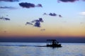 Fishing boat sailing at sunset Royalty Free Stock Photo