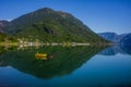 Fishing boat sailing on water with mountains in Norway. Royalty Free Stock Photo