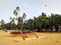 Fishing boat on a sandy beach with palm trees