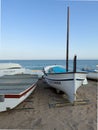 Fishing boat on sandy beach at sunset in Pineda de Mar, Spain