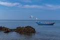 A fishing boat in a sea with Blue Sky background