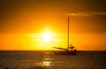 Fishing boat silhouette in ocean over evening sunlight Royalty Free Stock Photo