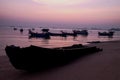 Fishing boat silhouette with orange sunrise sky and water reflection Royalty Free Stock Photo