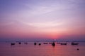 Fishing boat silhouette with orange sunrise sky and water reflection Royalty Free Stock Photo