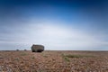 A solitary fishing boat on a deserted pebble beach