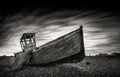 Fishing boat stranded on a pebbled beach. Dungeness, England