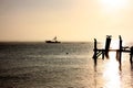 Fishing boat at sunset with birds on the pier. Royalty Free Stock Photo