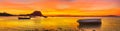 Fishing boat at sunset time. Le Morn Brabant on background. Panorama Royalty Free Stock Photo