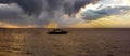 Fishing Boat at sunset under Storm Clouds Royalty Free Stock Photo