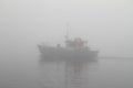 Fishing boat in thick fog Royalty Free Stock Photo