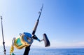 Fishing boat trolling in ocean with golden reel